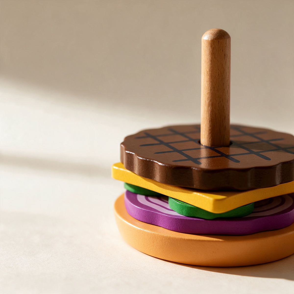 Close-up of the stacked wooden burger layers and natural wood peg