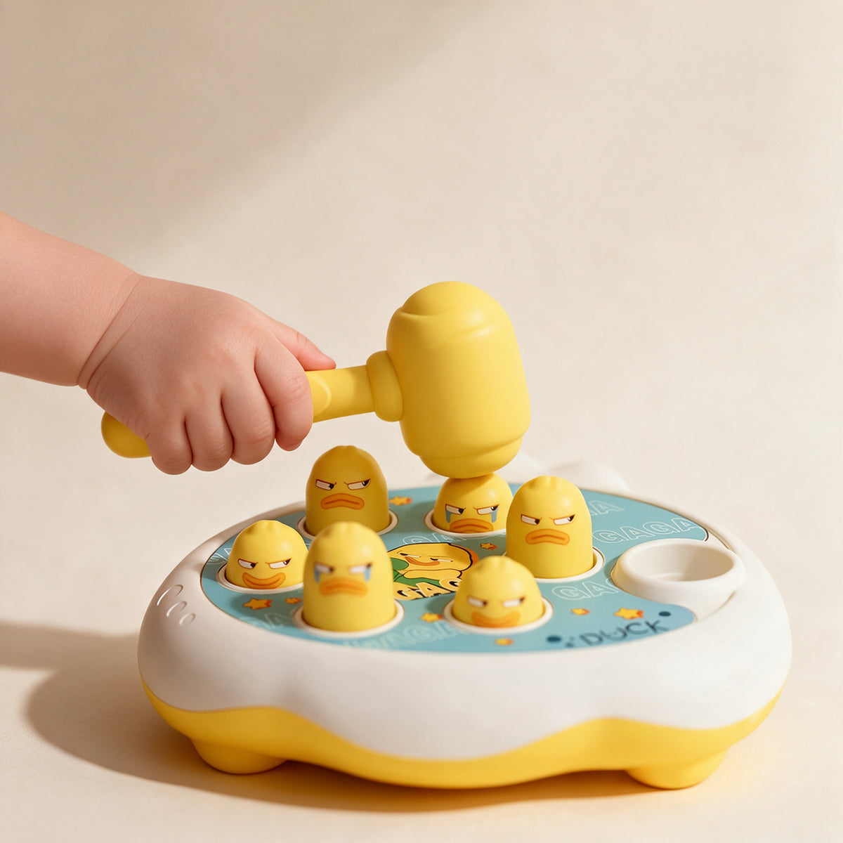 Toddler tapping a pop-up duck with the soft hammer